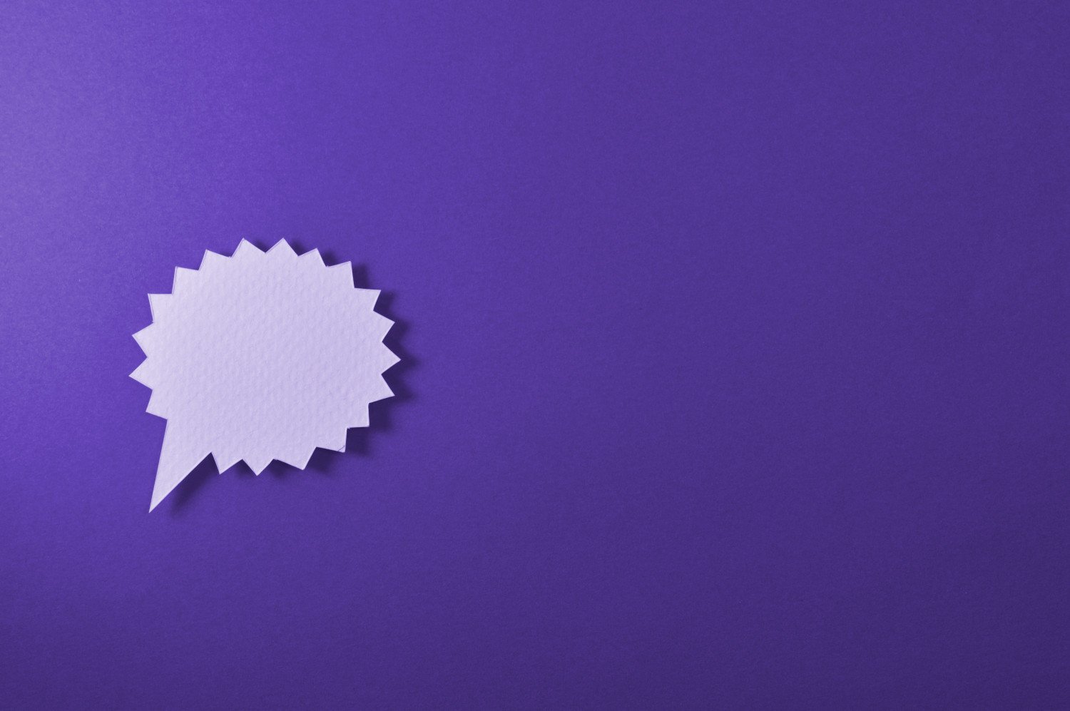A purple background with a spiky speech bubble.